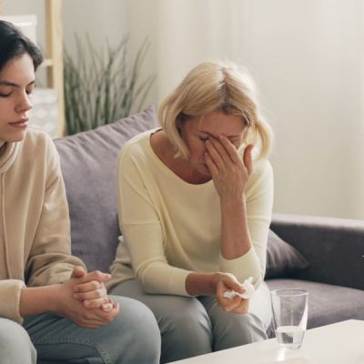 Adult child being comforted by a parent during addiction recovery support in Calgary