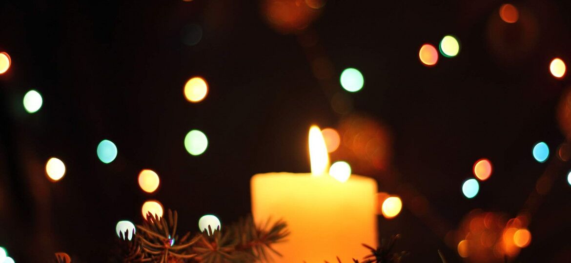 holiday candle lit in dark