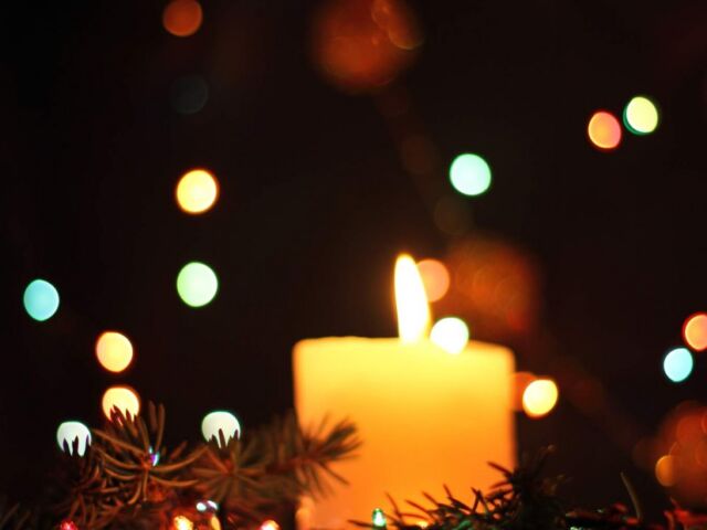 holiday candle lit in dark