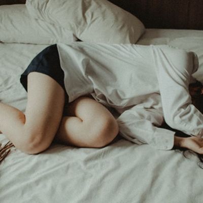 depressed woman lying on bed