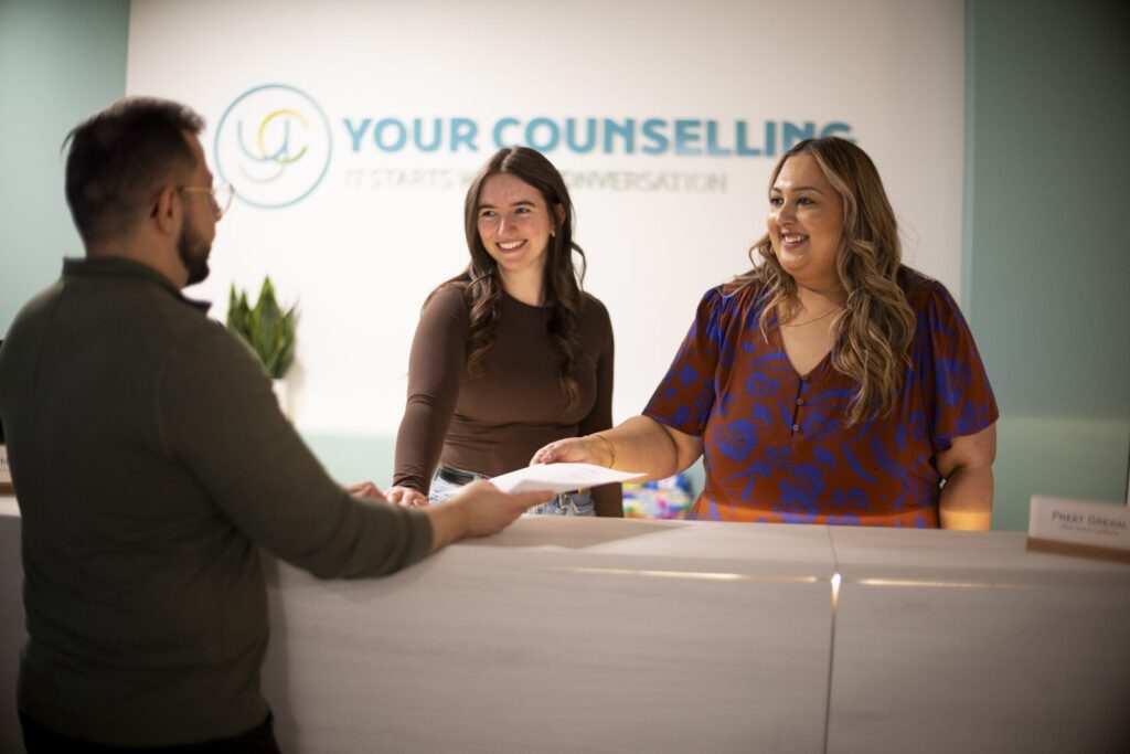 The Client Services Team welcoming a client at the Your Counselling front desk